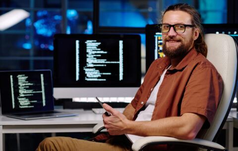 young-smiling-male-it-engineer-in-eyeglasses-using-2023-04-04-18-49-50-utc